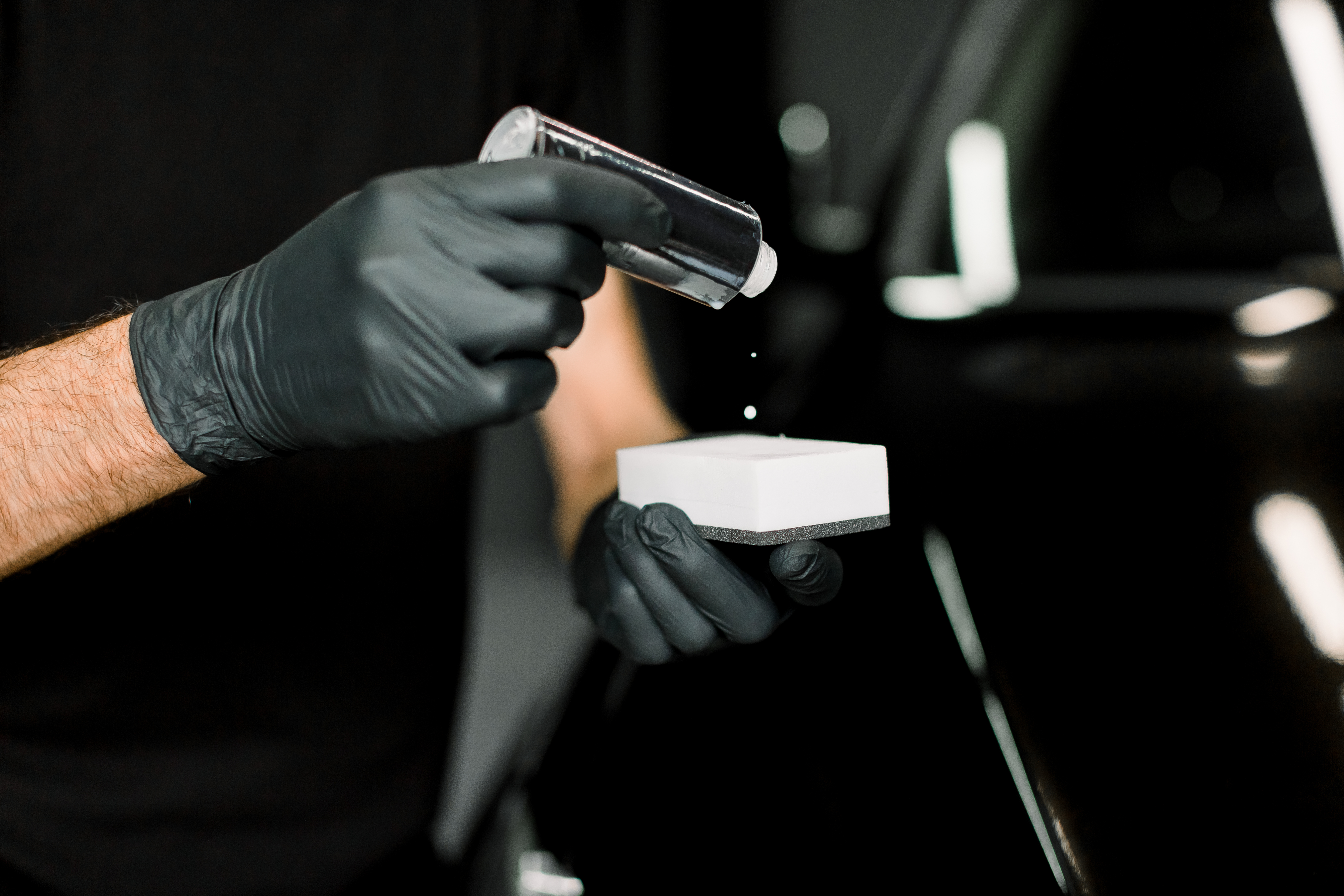 Ceramic coating being applied to a vehicle